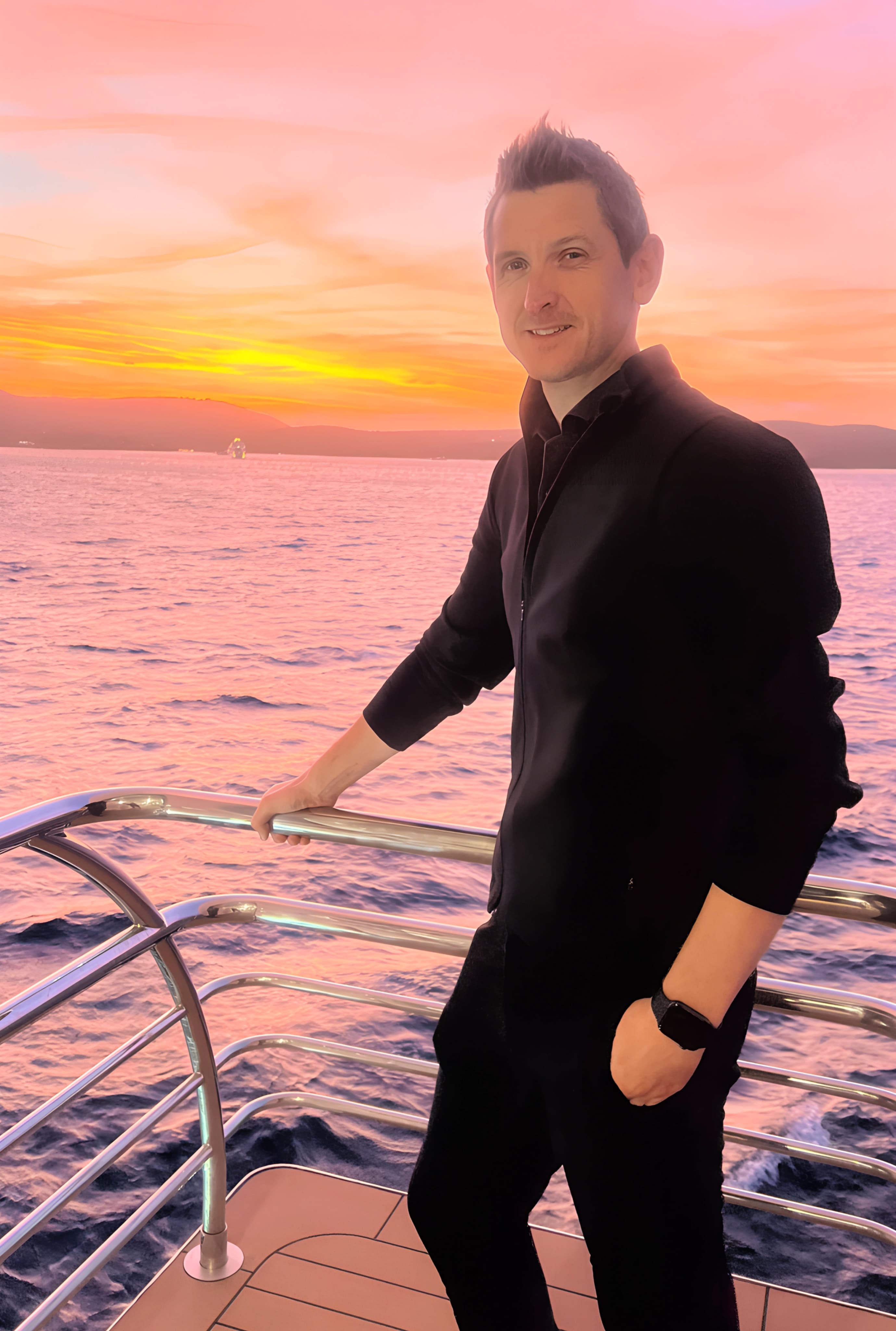 Founder of NEGU on a yacht at sunset