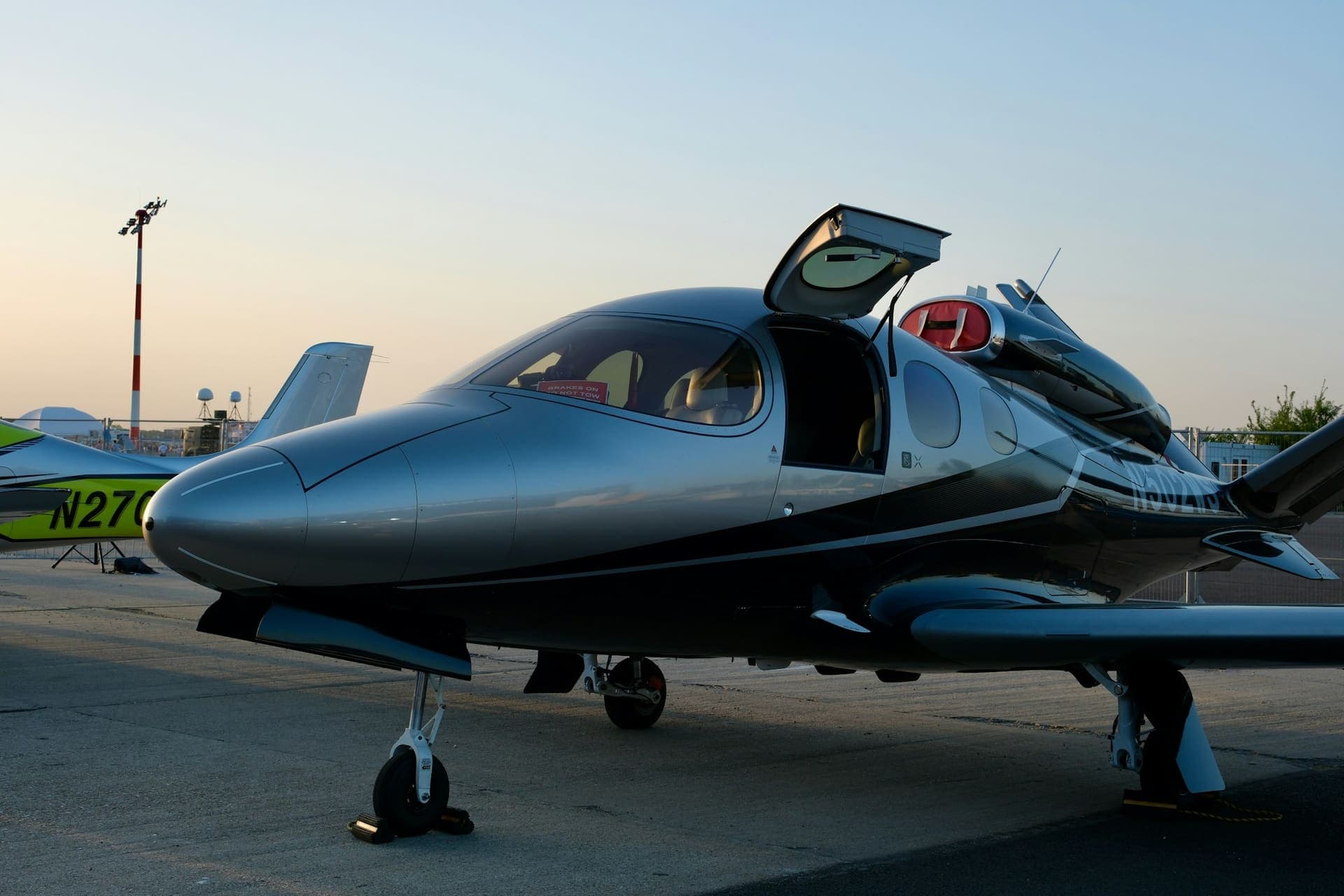 A light jet on the ramp at dusk with its cabin door open